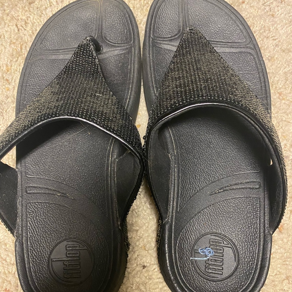 Black sequined flip flops by FitFlops